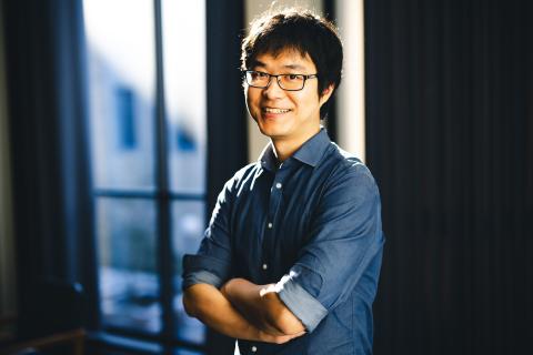 Chenshu Liu stands for a portrait smiling at the camera